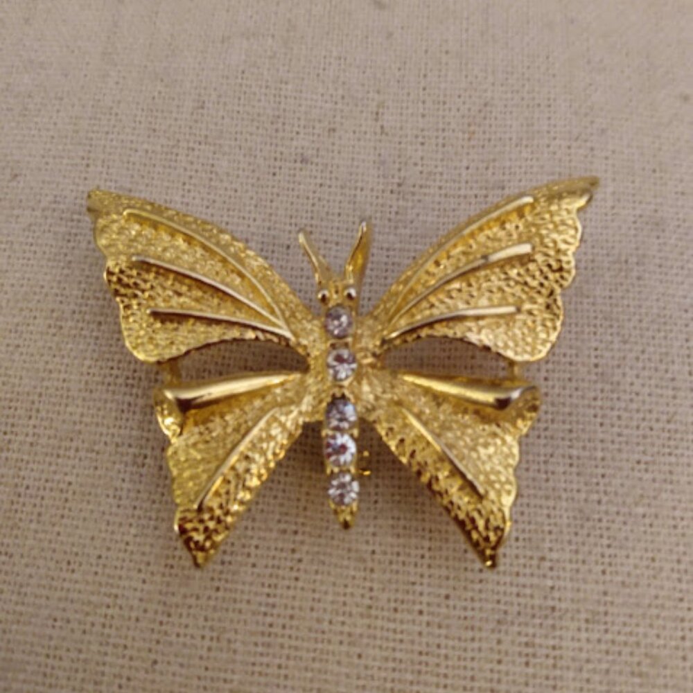 Gerry's: marked. Gold tone butterfly brooch with rhinestones.